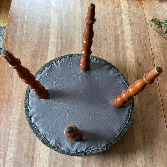 Upholstered green footstool