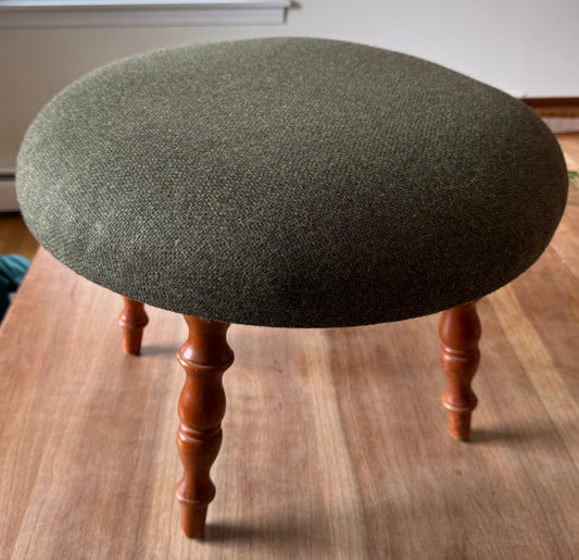 Upholstered green footstool